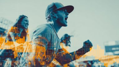 Cheering fans at a baseball game in an outdoor stadium