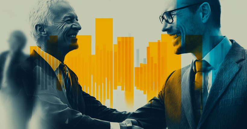 Two men smile at each other while shaking hands.