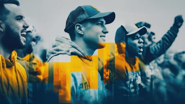 A group of fans wearing hats and hoodies standing outside at a sporting event