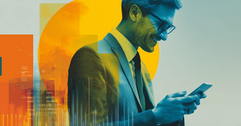 A man in a suit and glasses, smiling as he looks down at his smartphone
